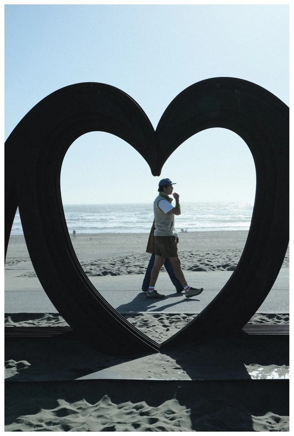 Two People walking along side a heart